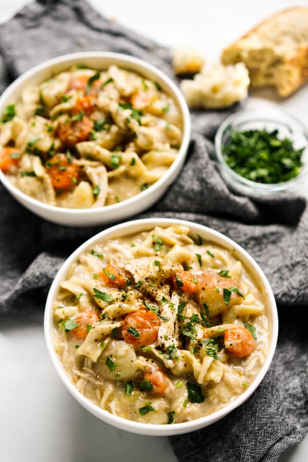 Two bowls of thick and creamy chicken noodle soup