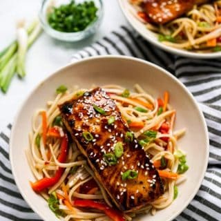 Two bowls of rice noodles topped with Orange Ginger Salmon