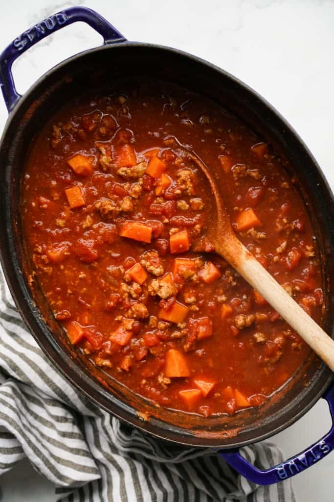 A large pot containing ground turkey and sweet potato chili