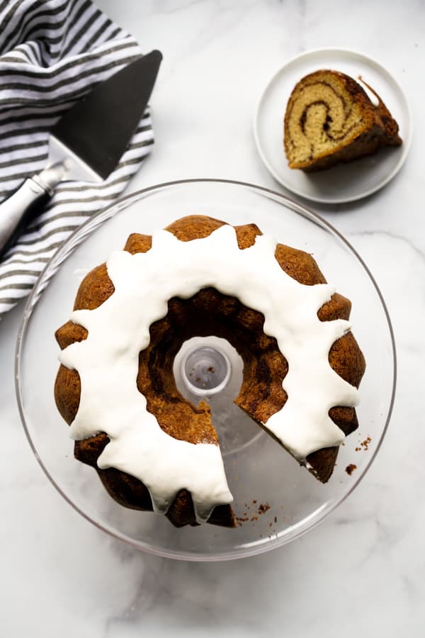 Top down view of a cut out bundt cake with the cut out slice on a separate plate