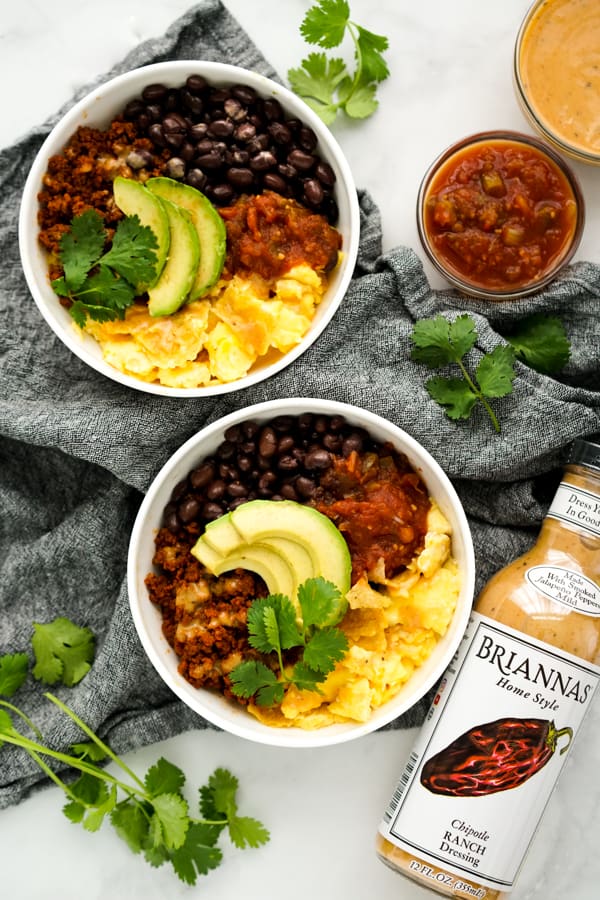 Two bowls of Mexican Breakfast Bowl and chipotle ranch dressing on the side