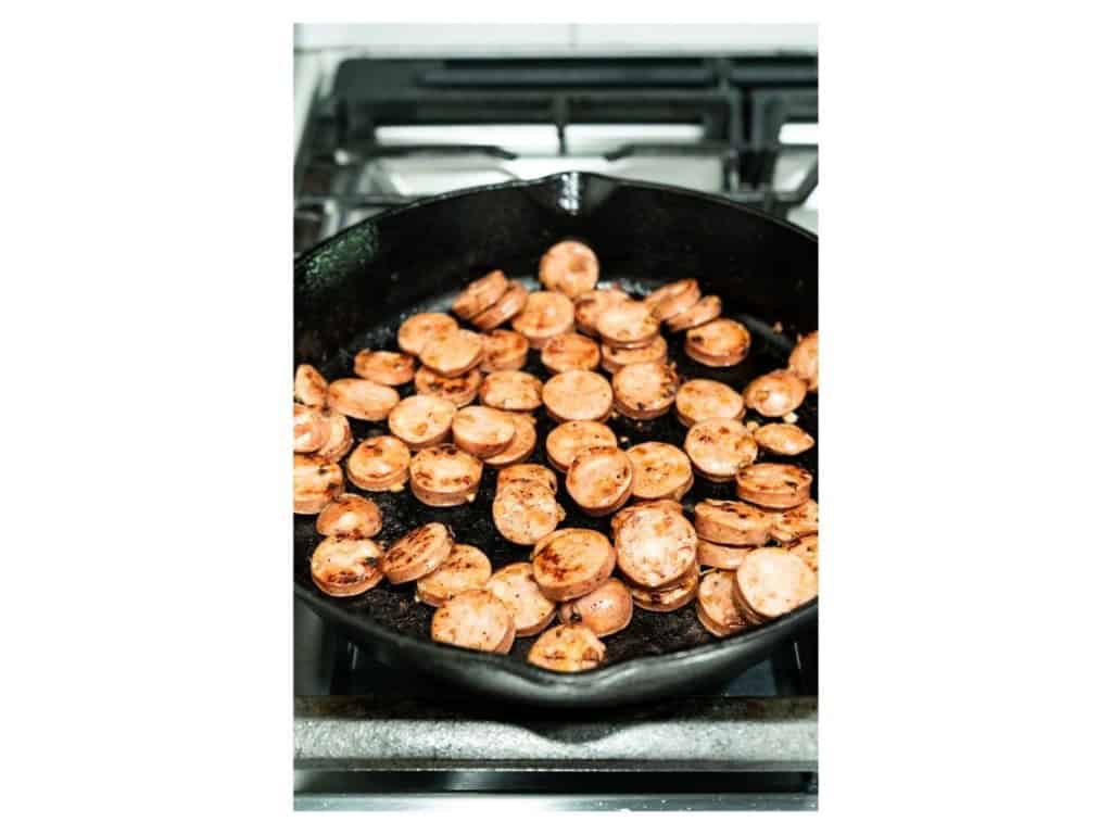 Pan frying sausage on a skillet