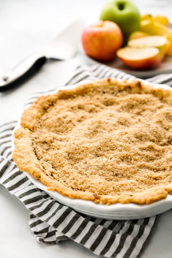 Lifting a slice of pie from a whole crumble pie