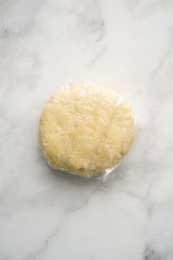 Pie crust dough wrapped in plastic wrap