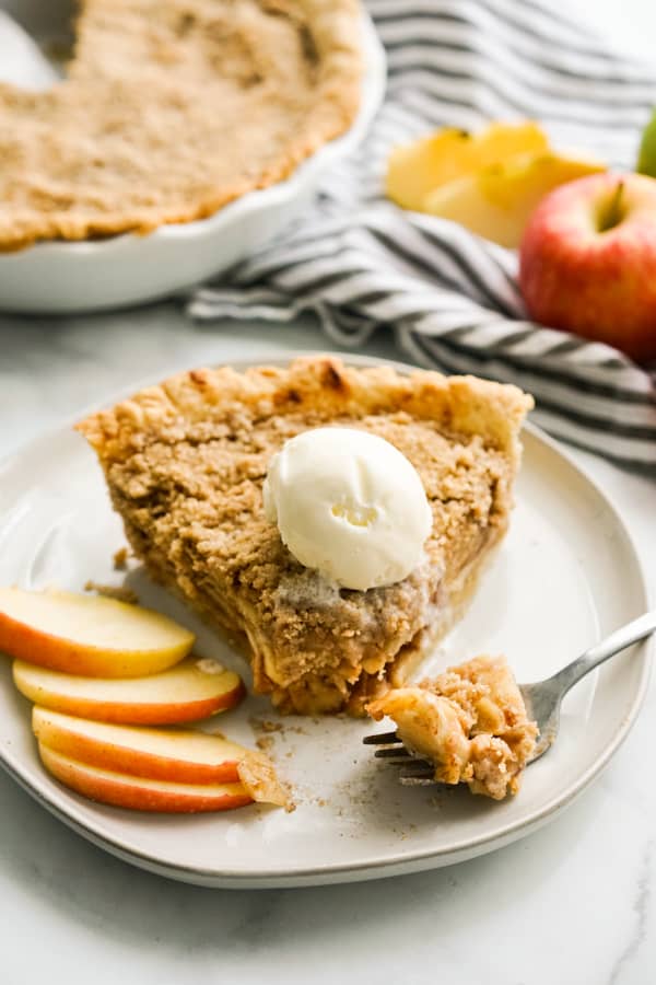Apple crumble pie with fork digging into it on the side