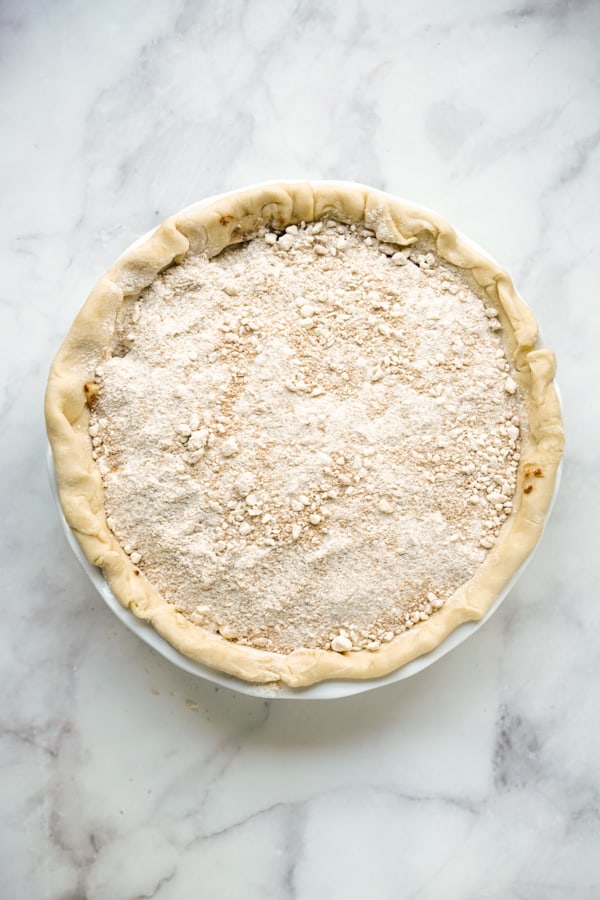 Unbaked apple pie topped with crumbles