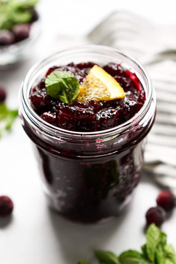 A bowl of cranberry sauce with orange slices on top