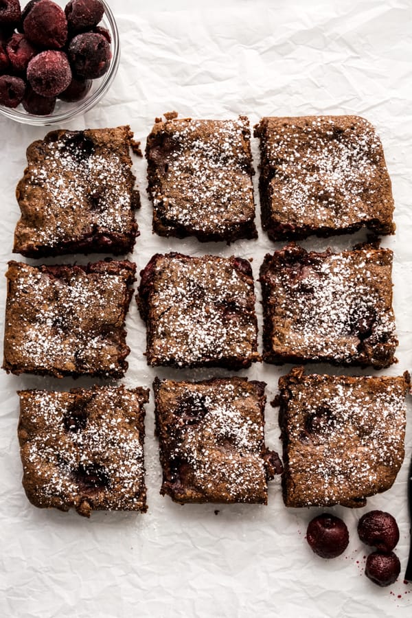 top down view of square brownie being cut into 9 squares