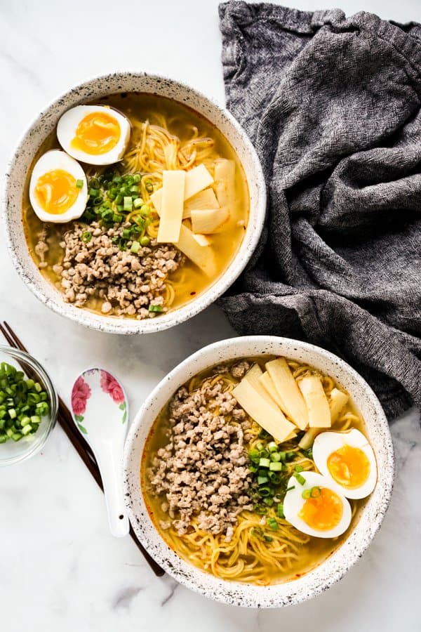 Top down view of two bowls of miso noodle soup