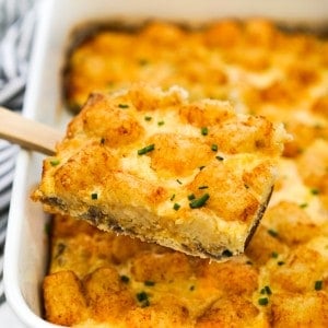 Lifting up a piece of sausage Tater tot breakfast casserole