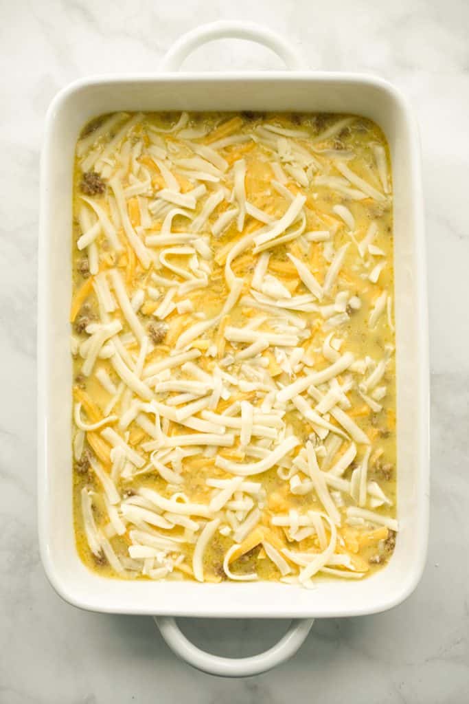 Sausage, eggs and cheese in a casserole prior to baking