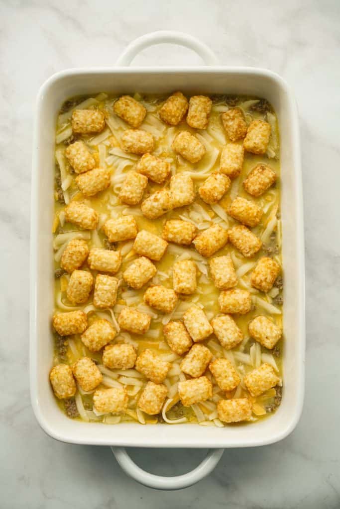 Sausage, eggs and cheese in a casserole with tater tots on top