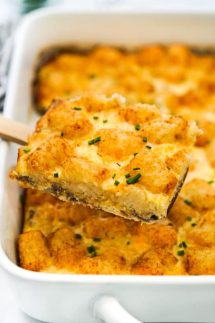 Lifting up tater tot breakfast bake out of the casserole dish