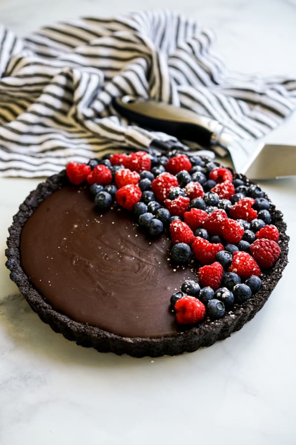 A round No-Bake Chocolate Tart topped with berries