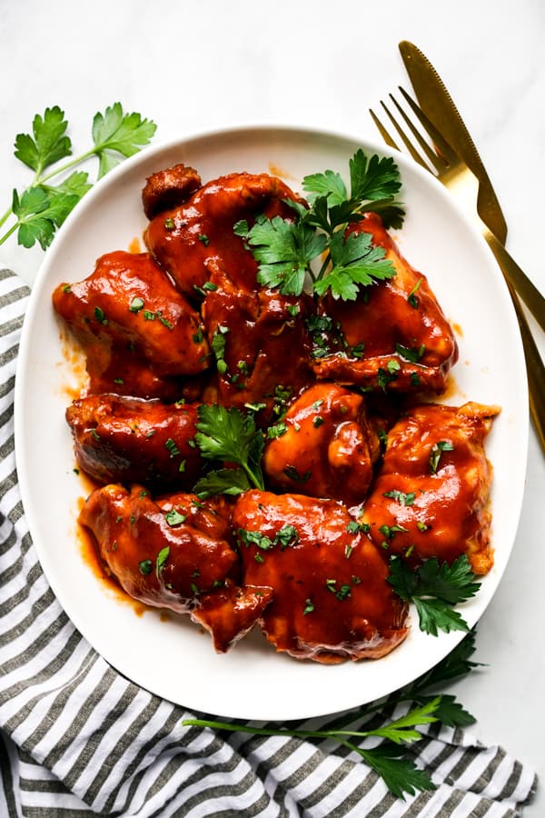 Top down view of an oval plate of BBQ chicken 