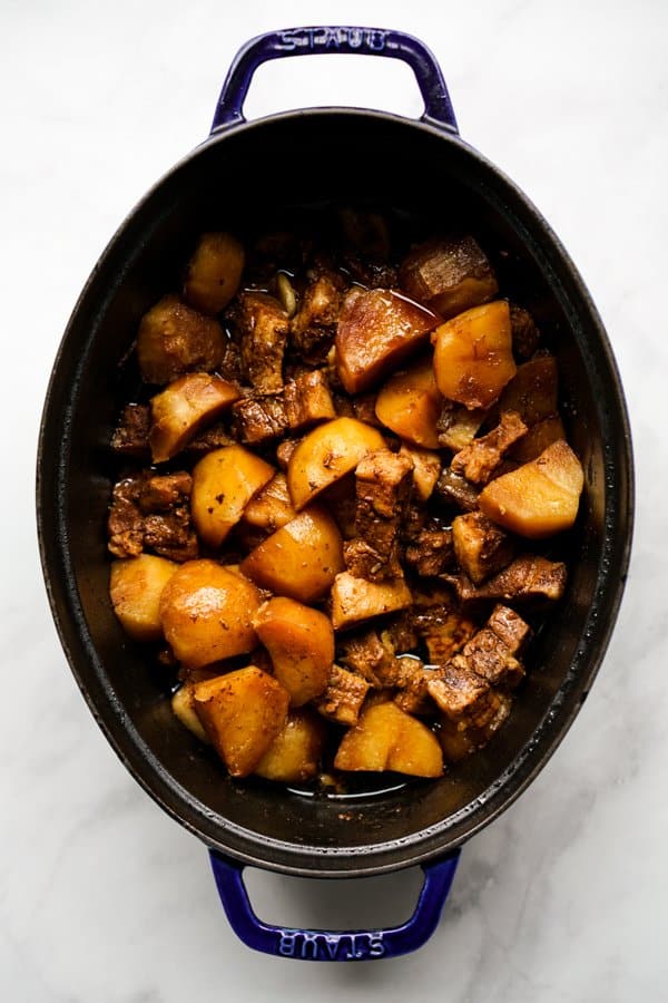 Craised pork bellow and potatoes in soy sauce in Dutch Oven