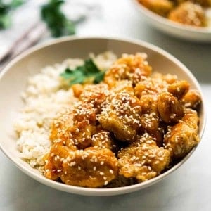 Closeup of a bowl of crispy honey sesame chicken