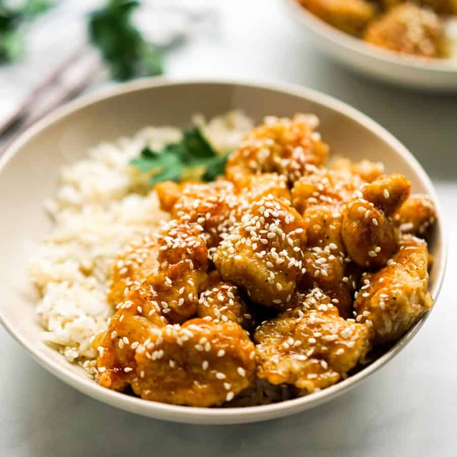 Closeup of a bowl of crispy honey sesame chicken