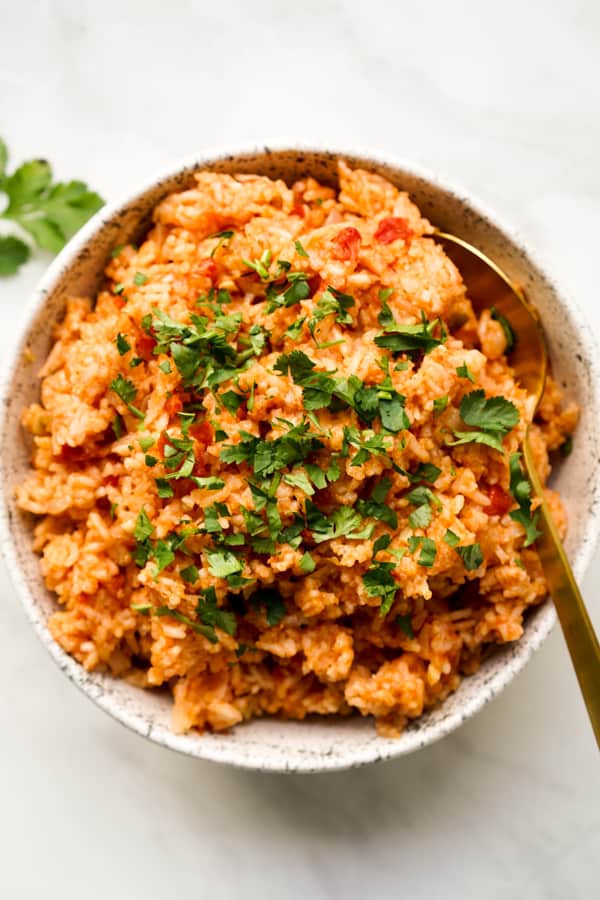 Top down view of a bowl of Mexican Rice with a spoon in the bowl