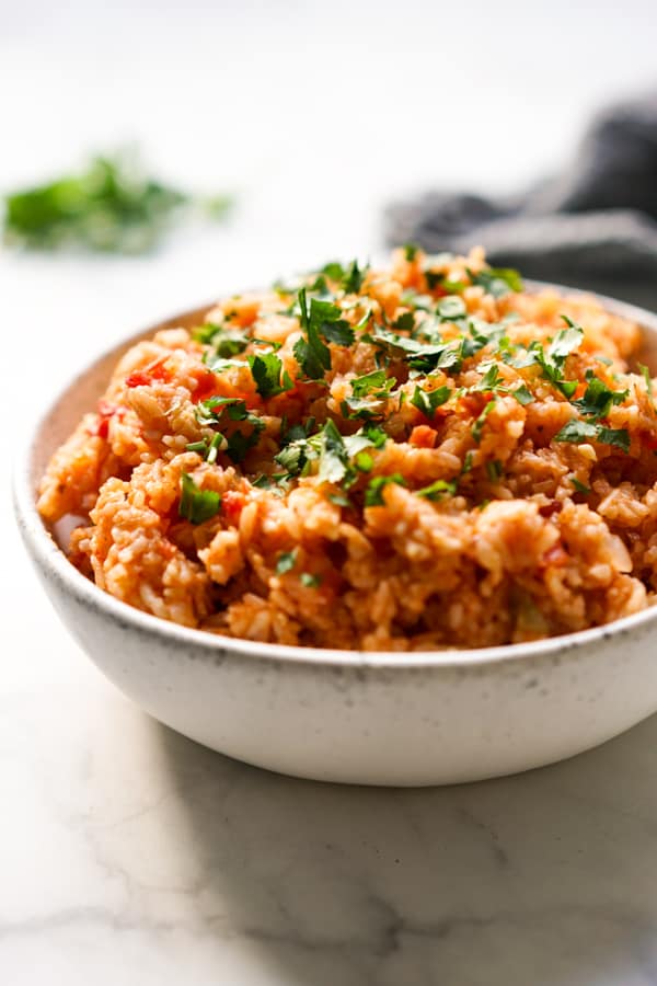 A bowl of Mexican rice topped with cilantro