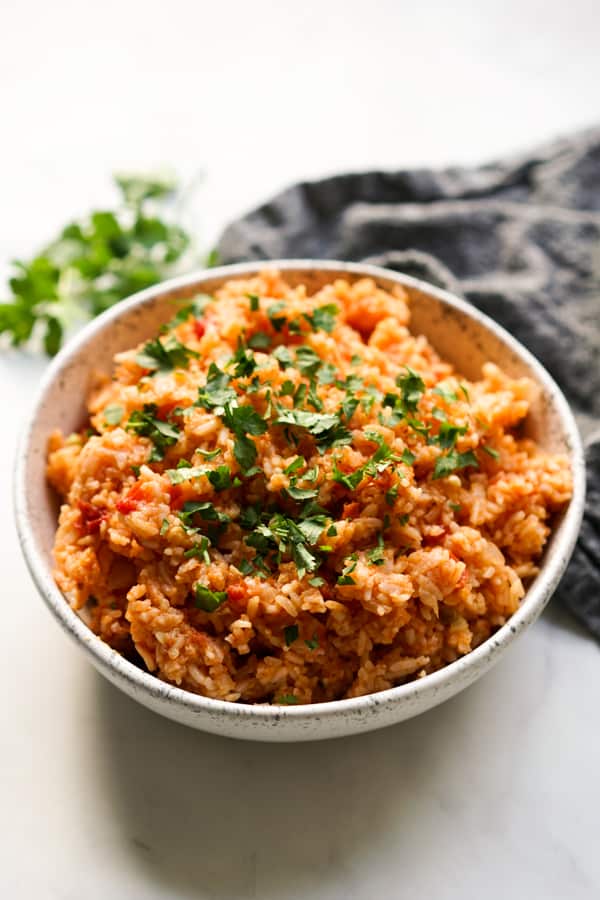 A bowl of seasoned Mexican rice topped with chopped cilantro