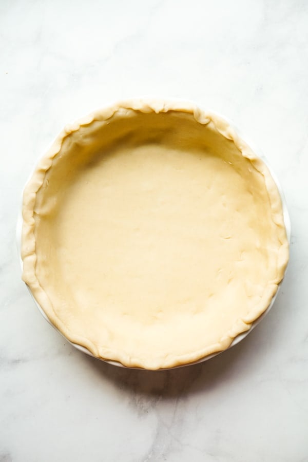 Unbaked pie crust on a round pie pan