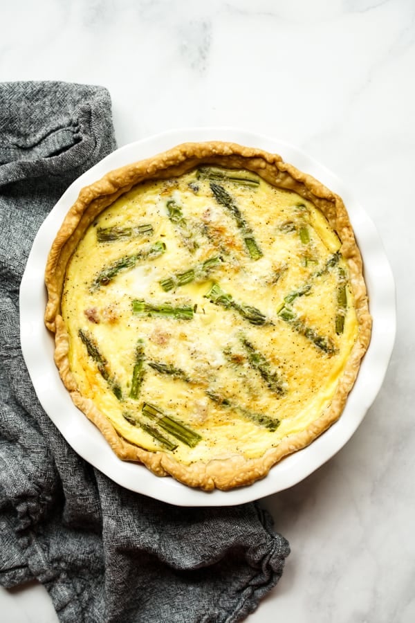 Top down view of quiche with asparagus