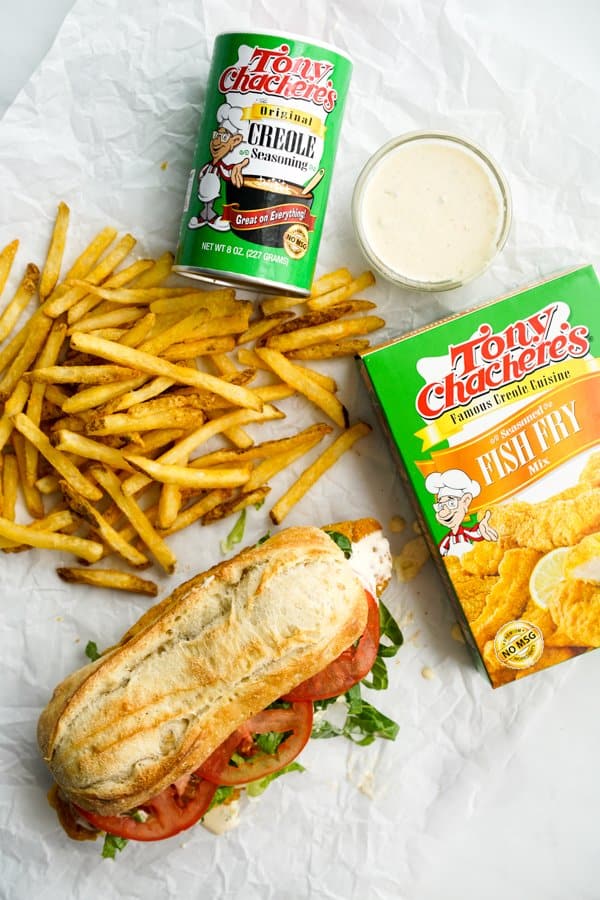 Top down view of Cajun seasoning, Fish Po' Boy, Fries, and Fish Fry Mix