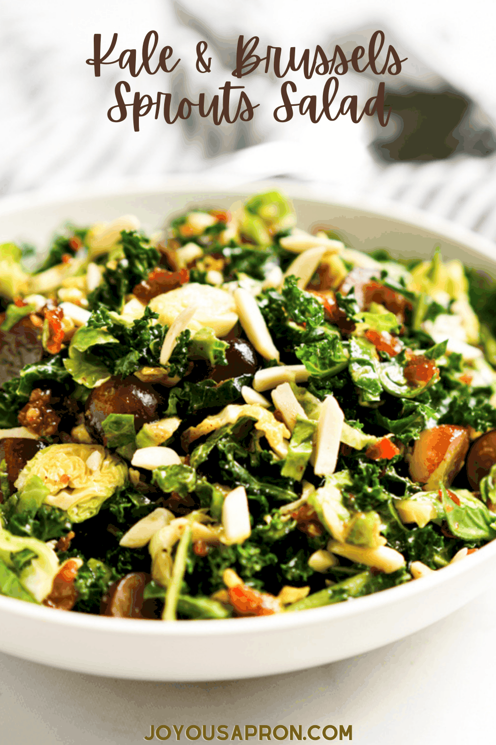 Kale and Brussels Sprouts Salad - healthy and delicious vegetable side dish! Crunchy Brussels sprouts and kale combined with grapes and slivered almonds tossed in a savory, sweet and tangy homemade Bacon Vinaigrette. via @joyousapron
