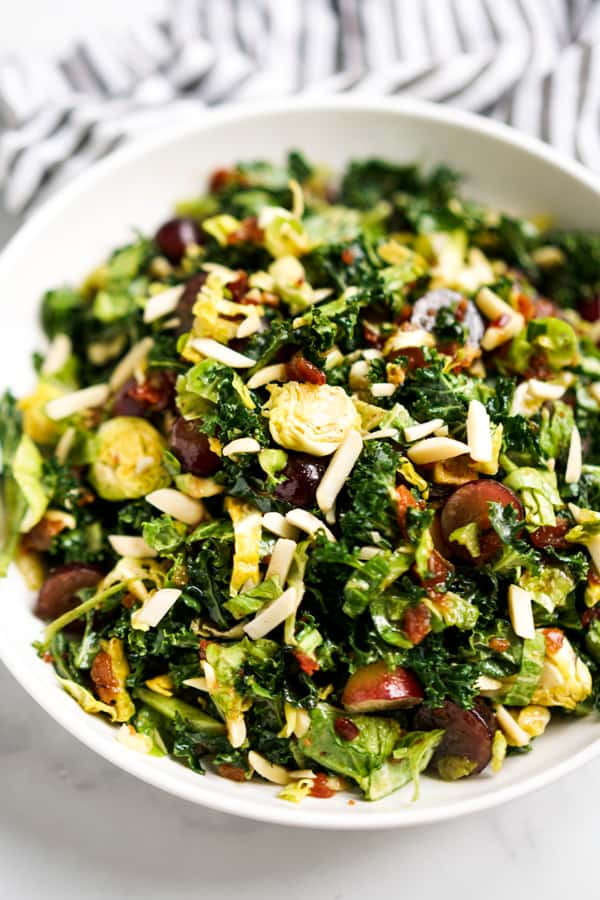 Close up of Brussels sprouts, kale tossed with grapes and slivered almonds