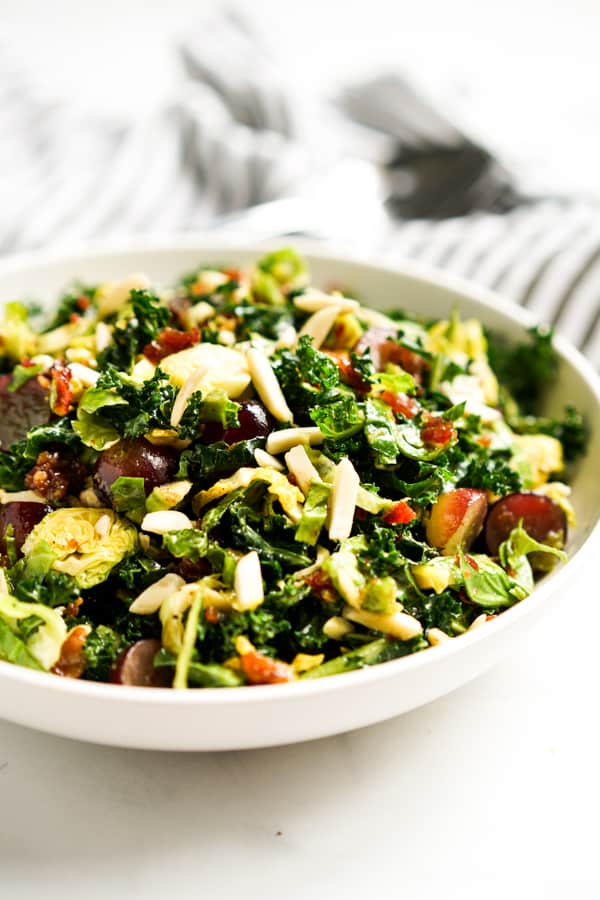 A bowl of Brussels Sprouts kale and grapes tossed together