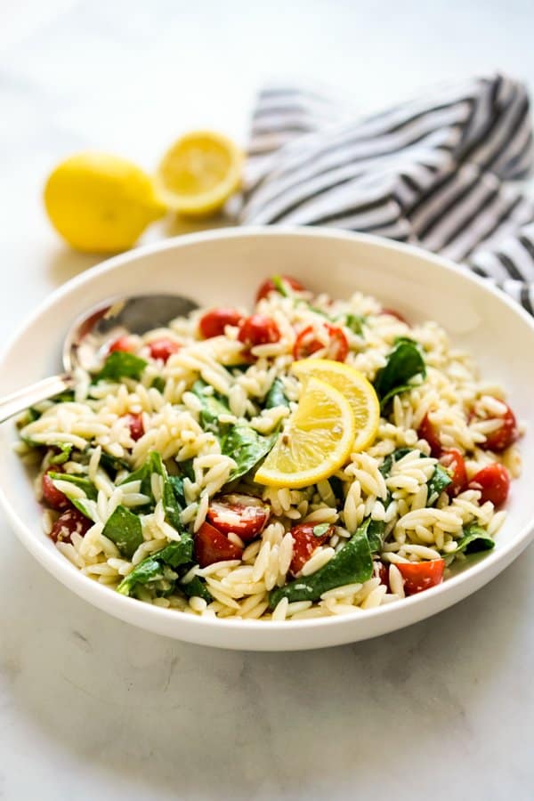 A bowl of Lemon Orzo Spinach Cherry Tomato Salad