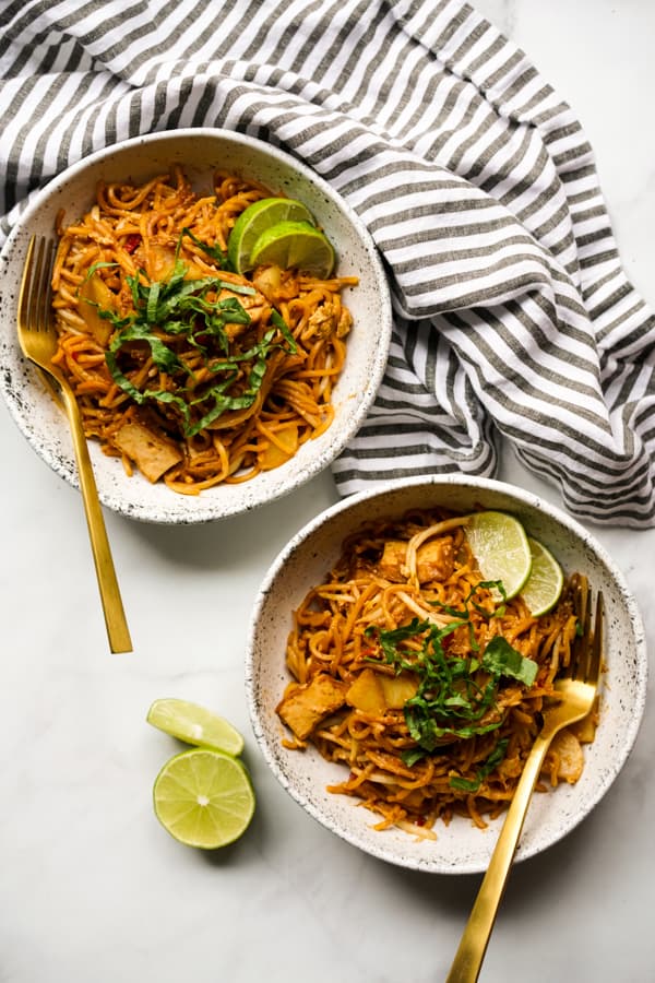 Two top down bowls of fried yellow noodles (Mee Goreng Malaysia)