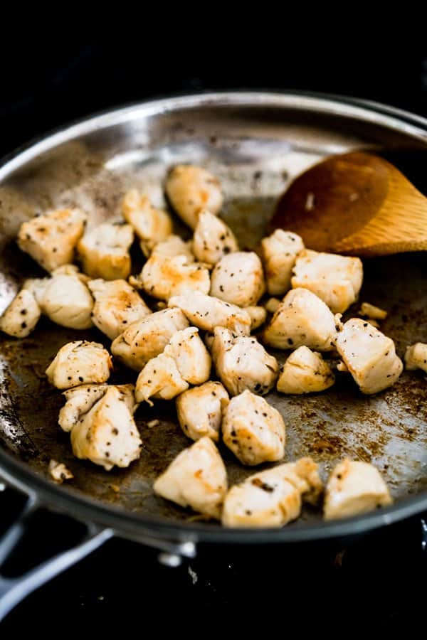 Sear chicken pieces in frying pan