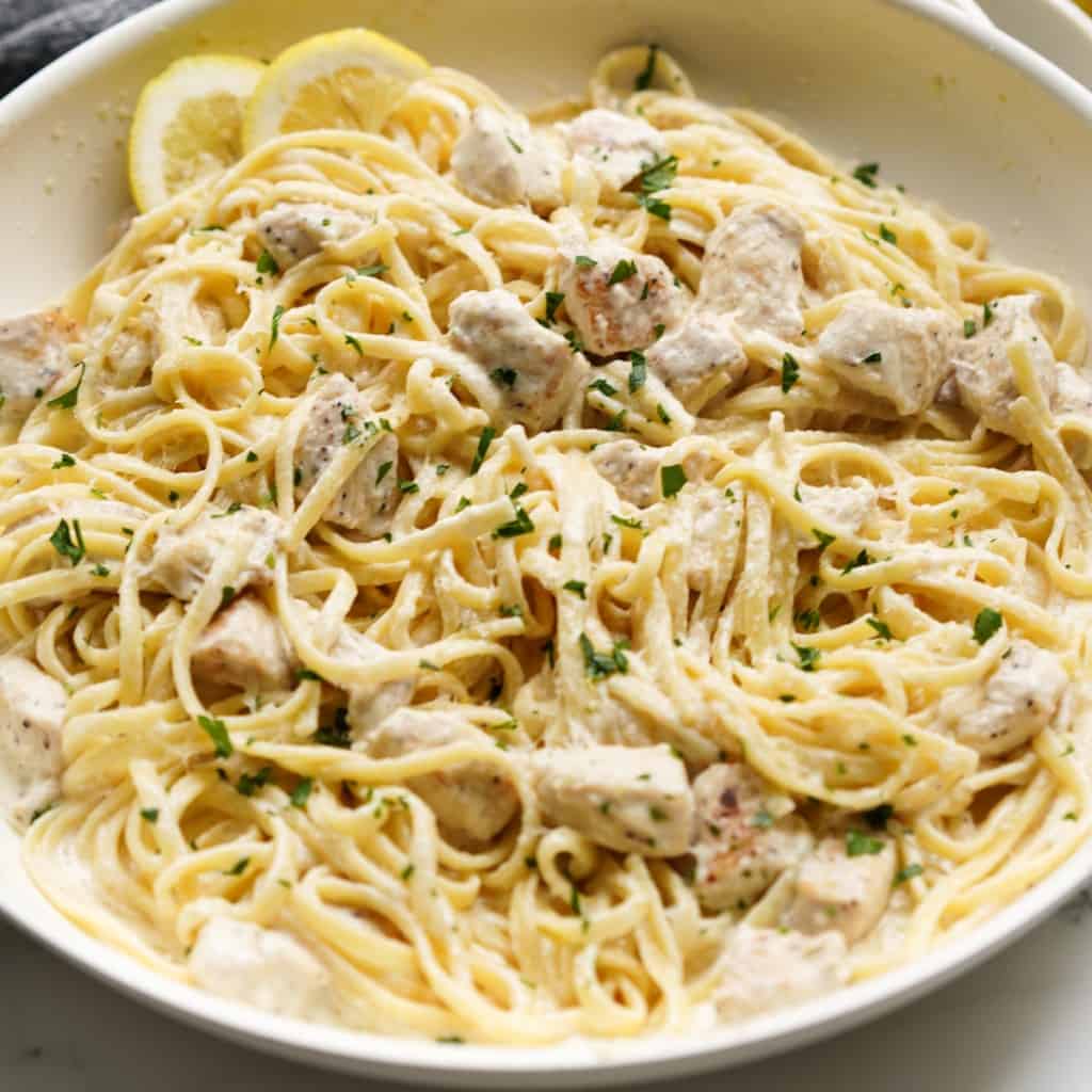 A skillet loaded with creamy lemon chicken pasta