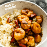 Shrimp over rice with a fork in the bowl