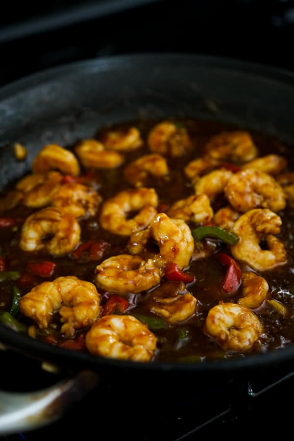 Shrimp, bell peppers and sticky sauce in a skillet