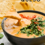 Tortilla chip dipped into a bowl of Easy queso dip