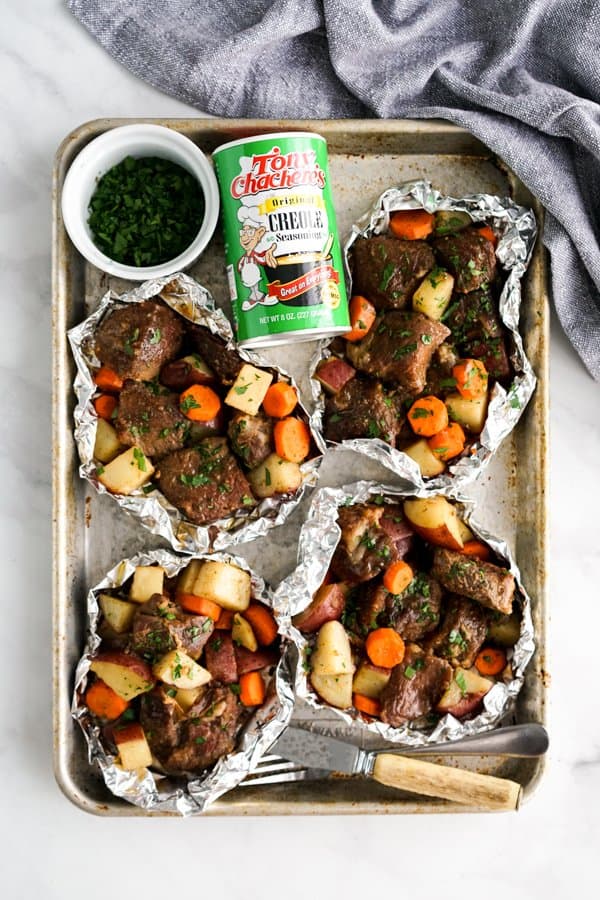 Cajun and Potato Foil Packs with Creole seasoning on a tray