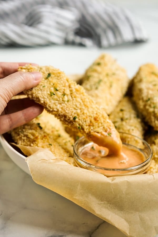 Dipping Baked Panko Chicken into dipping sauce