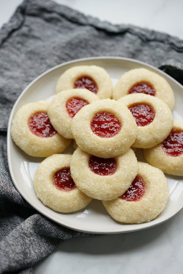 A stack of strawberry shortbread thumbprint cookies