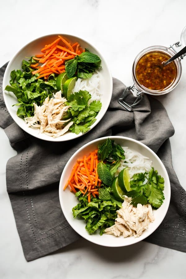 Top down view of two bowls of Vermicelli Noodle Bowls with sauce on the side