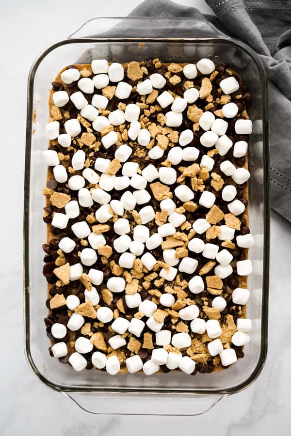 Chocolate chips and marshmallow on top of S'mores Bars crust