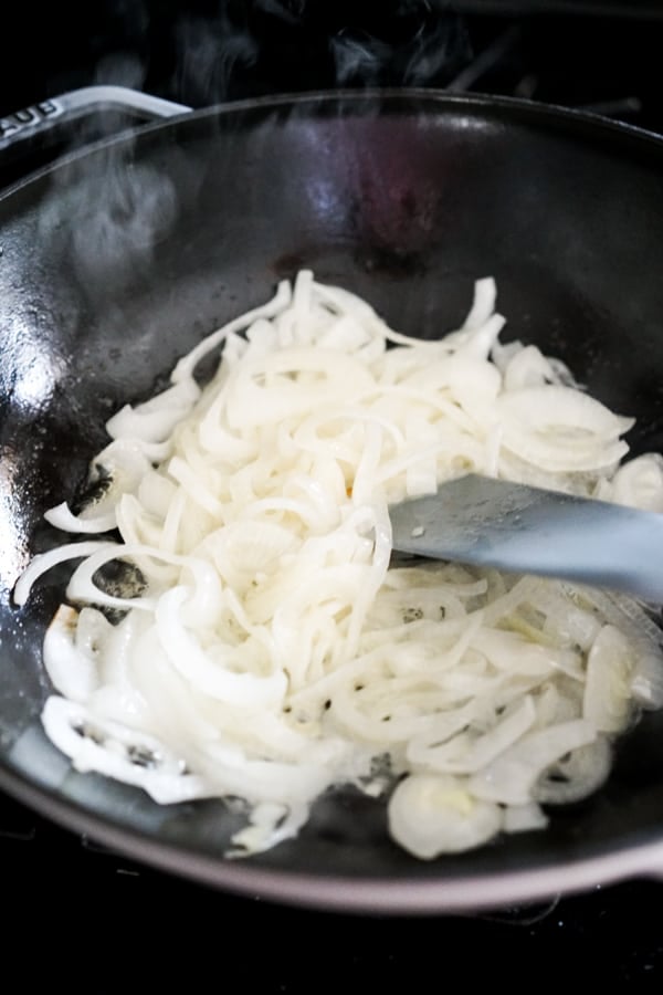 Raw white onions in a skillet