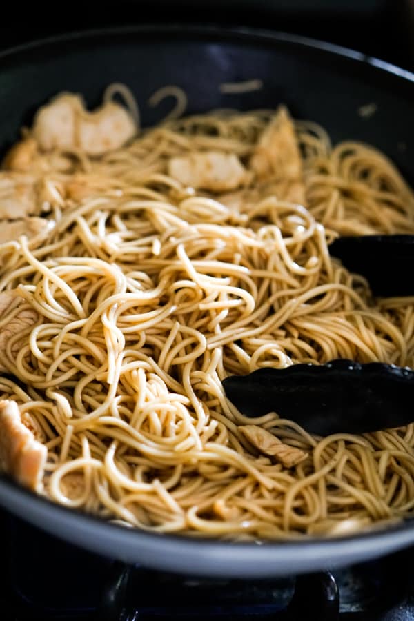 Stir frying noodles in a skillet