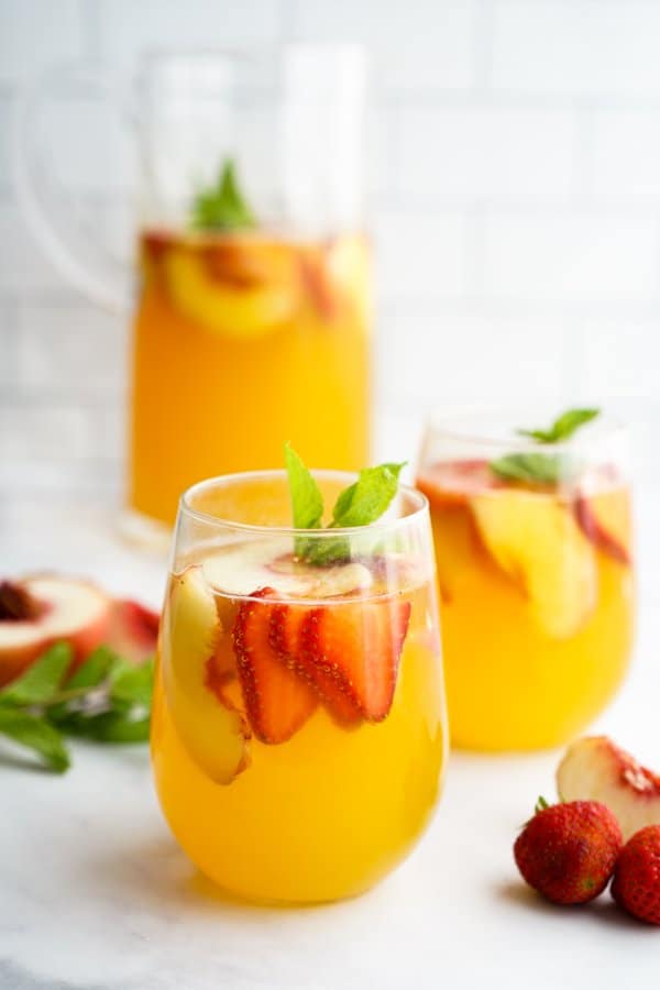 White Peach Sangria in glasses and a pitcher