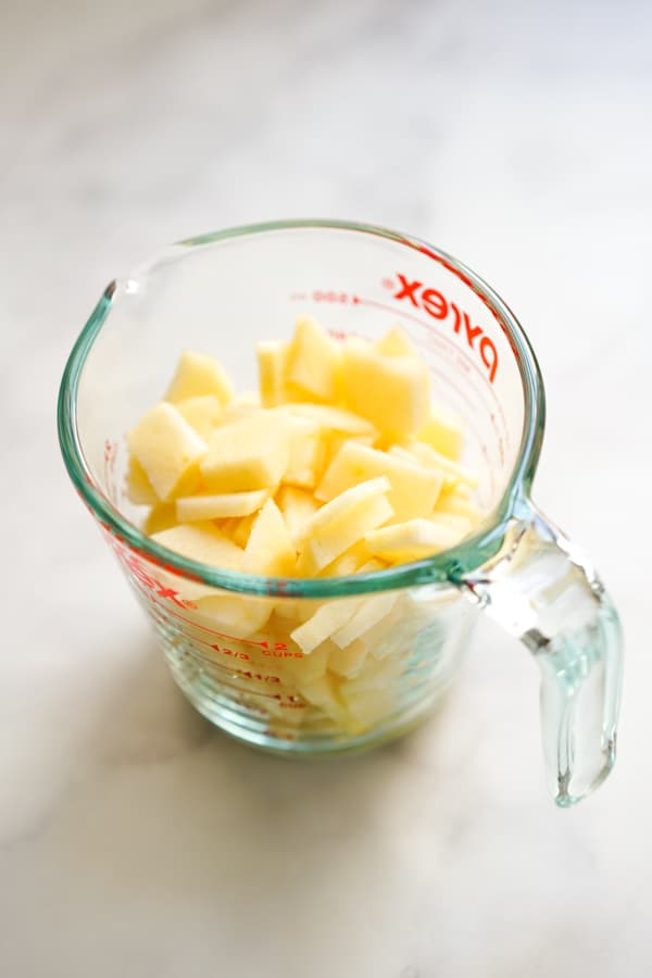 Sliced apples in a measuring cup