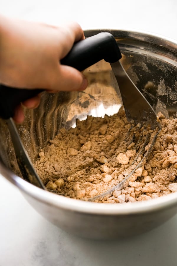 Cutting crumble ingredients with a pastry cutter