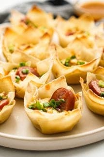 Wonton cups filled with cream cheese, sausage and green onions