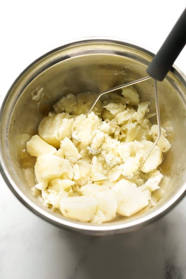 Mashing potatoes with a potato masher